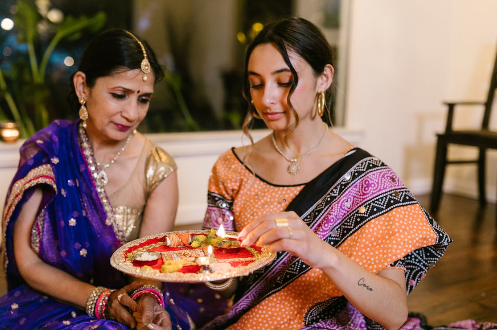 Indian women engaged in ceremony.