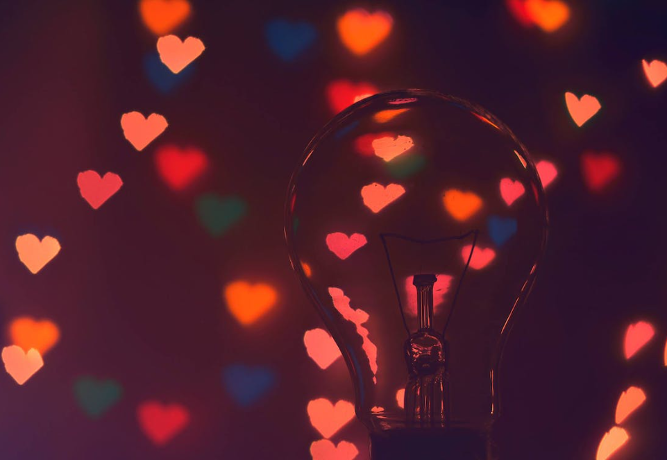 Lightbulb with colorful hearts