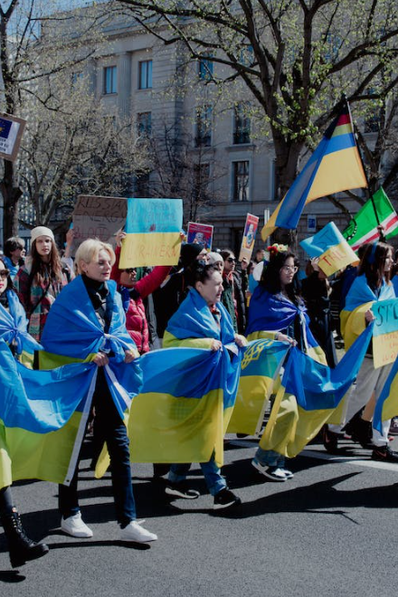 People protesting wrapped in Ukraine flags.