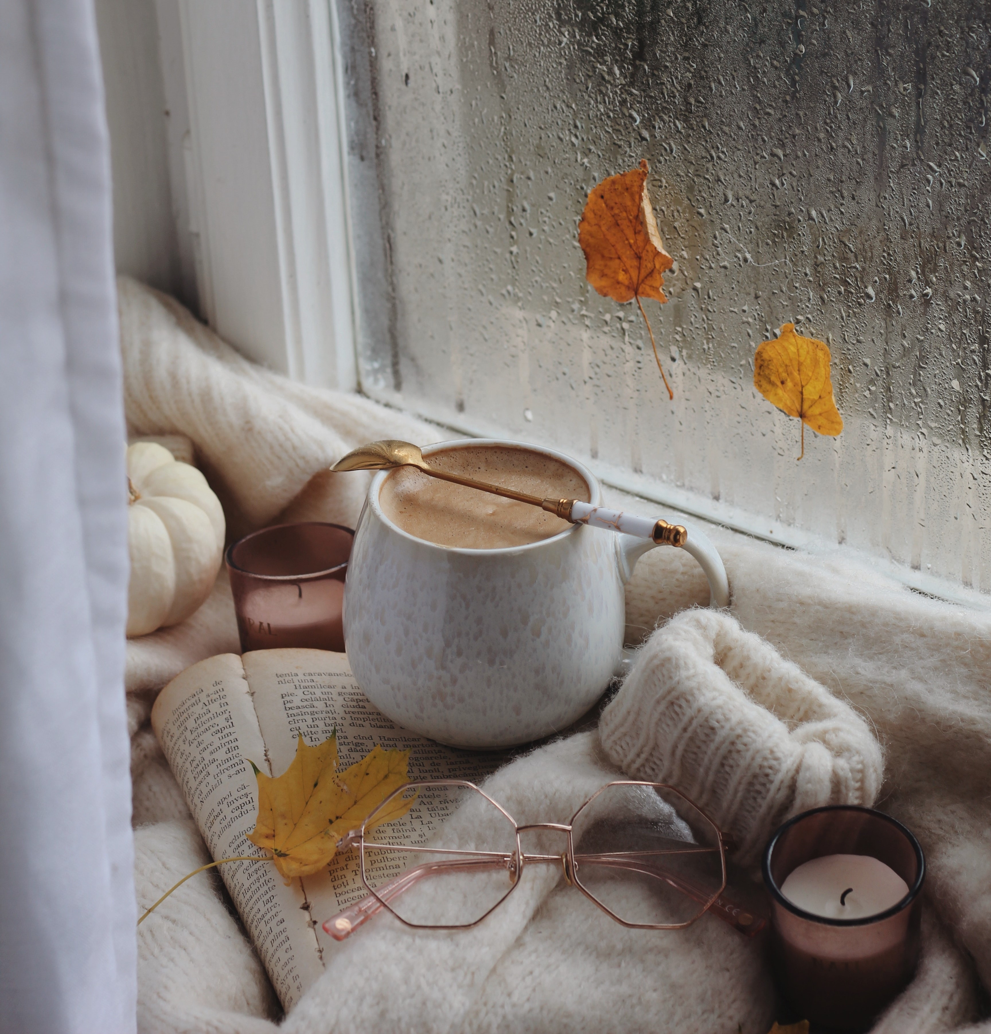 rainy window with mug of coffee and sweater