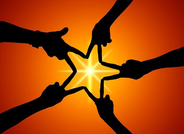 People holding a star together